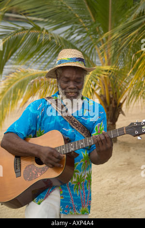 Jamaican playing a guitar on the beach Jamaica Caribbean Stock Photo
