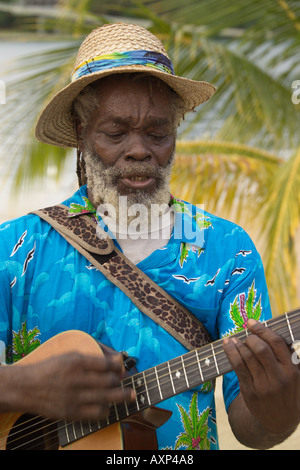 Jamaican playing a guitar on the beach Jamaica Caribbean Stock Photo