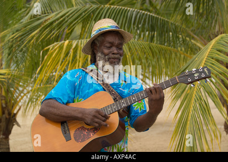 Jamaican playing a guitar on the beach Jamaica Caribbean Stock Photo