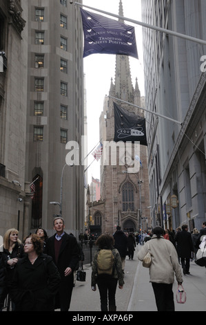 Tourists on Wall Street. Trinity Church is in the background. Stock Photo