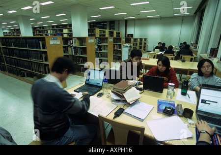 Peking University students study by themselves in Library. Stock Photo