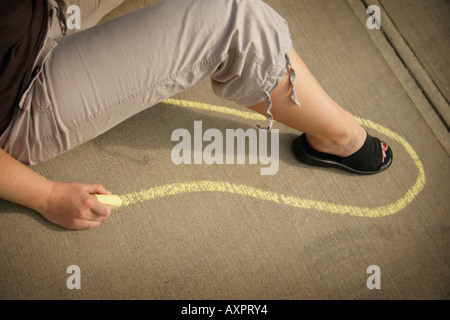 Woman drawing chalk outline Stock Photo