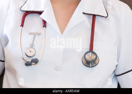 A nurse wearing a fob watch and a stethoscope around her neck Stock Photo