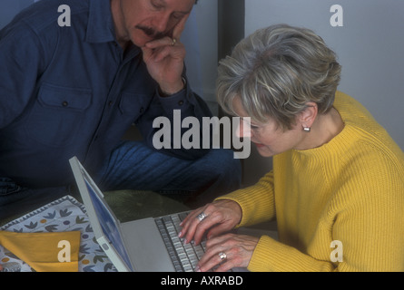 Man Watching Woman Working on Computer Stock Photo