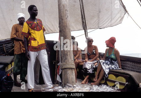 Sailing dhow or jahazi taking visitors on a sunset cruise of the caost of Kenya East Africa Stock Photo