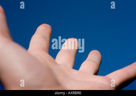 Hand reaching to the sky Stock Photo