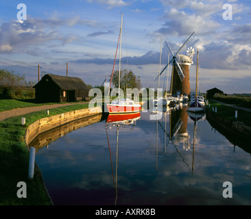 The windpump at Horsey on the Norfolk Broads reflected in the water, with stunning views over the open flat countryside Stock Photo