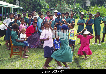 South Pacific Fiji Vitu Levu school class, kids dancing and singing outdoors Stock Photo