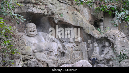 Laughing Buddha on the cliffs of the Peak Flying in from Afar at The Ling Yin Temple Hangzhou China Stock Photo