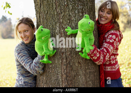 Two young women with frog hand puppets, selective focus Stock Photo