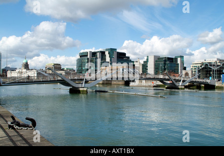 IFSC House and the AIB Trade Centre Building seen from the Sean O Casey Pedestrian Bridge over the River Liffey Dublin Ireland Stock Photo