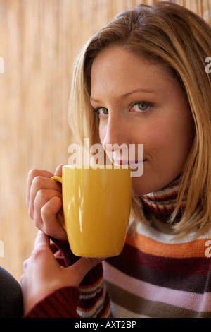Young woman with a cup in her hand, close-up Stock Photo