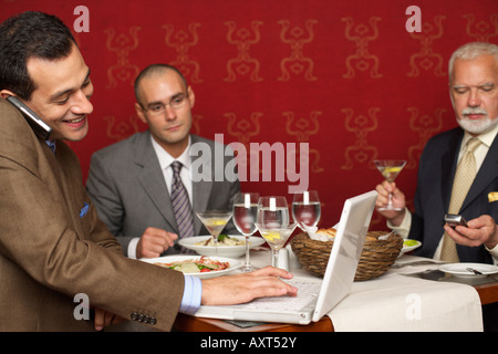 Three businessmen having a business lunch Stock Photo