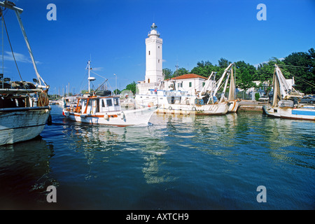 Boats and lighthouse at Rimini Harbour (Emilia Romagna) in Adriatic Sea on Riviera in Italy Stock Photo
