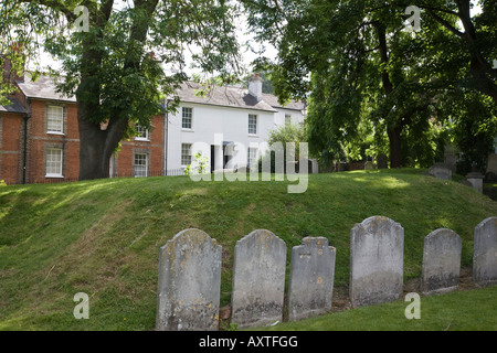 Gravestones in the churchyard of Holy Trinity church with period buildings in the background. Guildford, Surrey, England. Stock Photo