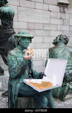 Human Statue eating a pizza outside the Cathedral of Our Lady, Antwerp. Belgium Stock Photo