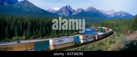 A freight train travelling through the Canadian Rockies at Morants Curve Banff National Park Alberta Canada Stock Photo