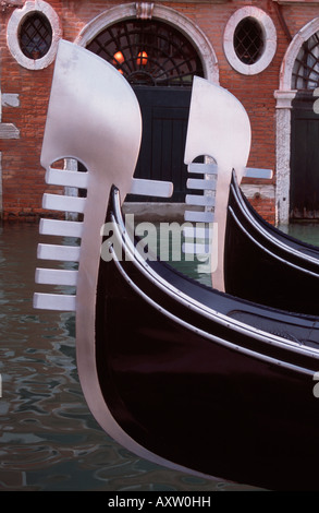 Front bows of two Venetian gondolas, with their distinctive metal Ferros Stock Photo