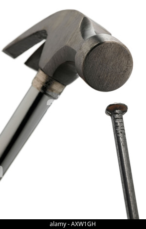 a claw hammer comming down on a nail Stock Photo