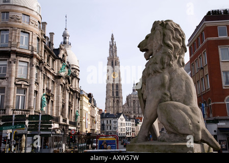 Stone Lion statue with Cathedral of Our Lady, Antwerp, in background. Belgium. Cathedral local name is: Onze Lieve Vrouwkerk Stock Photo