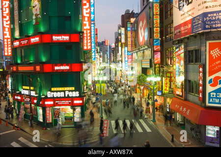 Busy streets and neon signs in the evening at Shinjuku station, Shinjuku, Tokyo, Japan, Asia Stock Photo