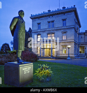 illuminated statue of Friedrich Alfred Krupp (1854-1902) in front of the Small House of the Villa Huegel, Germany, North Rhine- Stock Photo