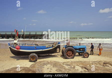 Fishing boat and tractor about to launch into the North Sea at Happisburgh, Norfolk Stock Photo