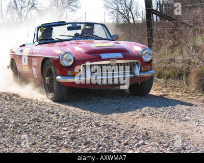 red rally MGC convertible at speed on gravel road International Horneland Rally Netherlands Stock Photo