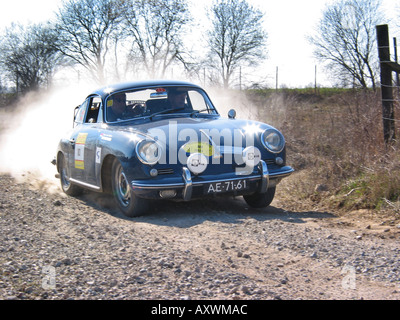 blue rally Porsche 356 saloon at speed on gravel road International Horneland Rally Netherlands Stock Photo