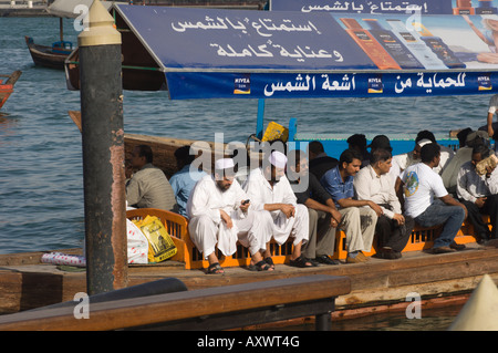 Passangers on an abra, the small ferries that cross Dubai Creek, Dubai, United Arab Emirates, Middle East Stock Photo