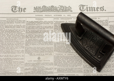 old fashioned iron lying on old copy of The Times newspaper  newton house Dinefwr Park and House  UK Stock Photo