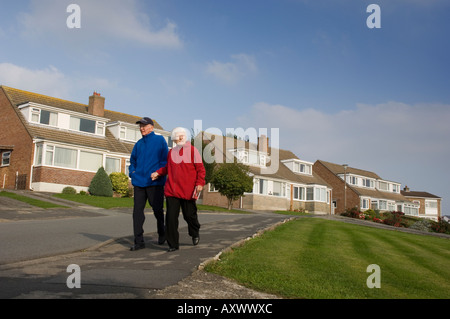 an elderly couple walking on a sunday afternoon waunfawr aberystwyth 1960 s suburban housing estate wales UK Stock Photo