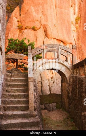 Steps, bridge, and last sunrays on rock face, White Cloud scenic area, Huang Shan (Yellow Mountain), Anhui Province, China Stock Photo