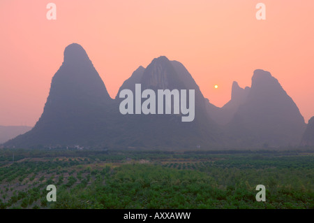 Karst landscape and setting sun, Yangshuo, Guangxi Province, China, Asia Stock Photo