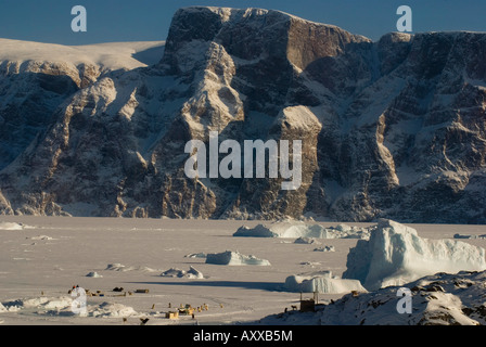 Icebergs frozen into the sea in North Greenland in winter Stock Photo