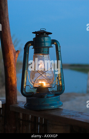 Lit hurricane or kerosene lamp at camp by the Kilombero River, Tanzania Stock Photo