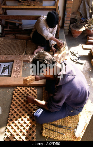 Nepal Patan crafts Men carving decoration on door frame and screen Stock Photo