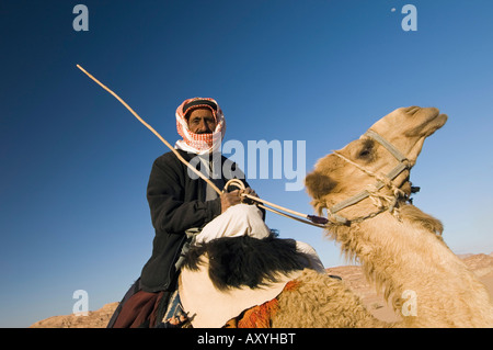 Bedouin on camel in the desert, Wadi Rum, Jordan, Middle East Stock Photo