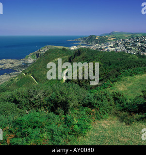 Scenic summer view east over Ilfracombe the coastline and sea from bush covered hills of Torrs Park Devon England Stock Photo