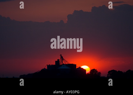 The sun sets behind a grain elevator in Central Illinois. Stock Photo