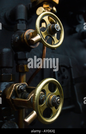 Detail of the brass control valves on a narrow gauge steam locomotive Stock Photo