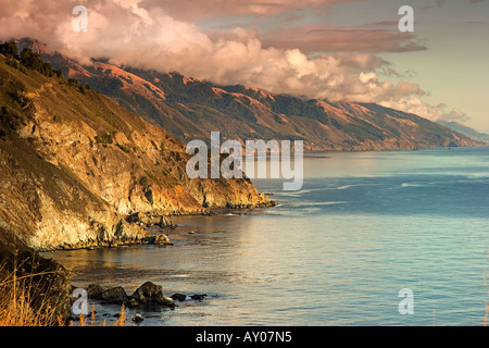 Setting sun reflects warm light over the central California coast at Grimes Point in Big Sur Stock Photo