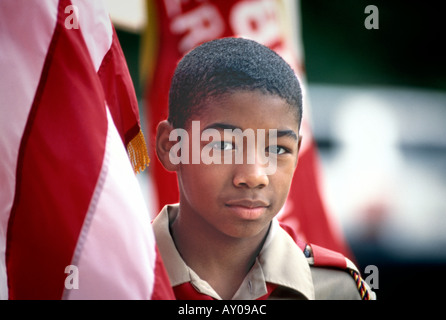 African American Boy Scout with Flag looking at camera face Stock Photo