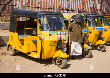 A row of Tuk Tuks parked in a street, and driver, Madurai, Tamil Nadu, India Stock Photo