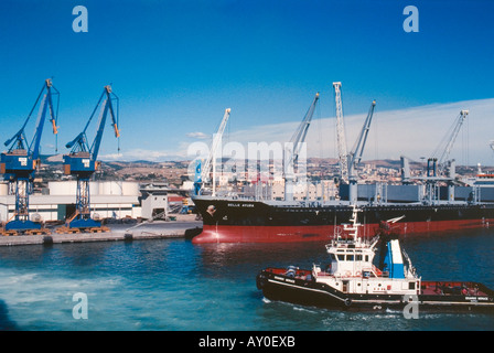 sea, water, sky, coast, ship, large, powerful, black, red, cranes, light, sun, harbor, , two big cranes, blue, yellow Stock Photo