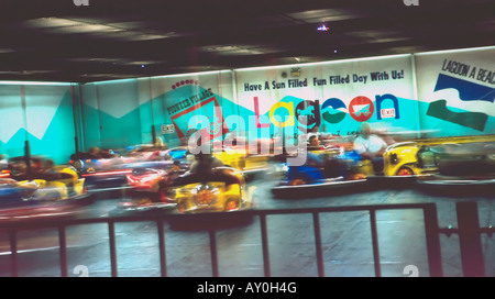 Blurred, in motion, bumper or dodge em cars going at it. Old and young drive frantically trying to smash and best other drivers. Stock Photo