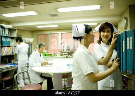 Doctor sand nurses working in nurses station Stock Photo