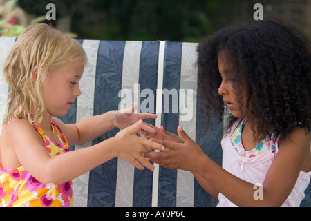 Children playing cats cradle Stock Photo