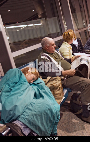 Traveler Sleeps in Airport Stock Photo