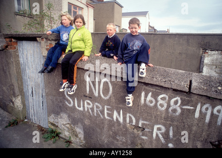 real local Children with IRA message in Derry, Northern Ireland Londonderry UK Killed with No Surrender painted sign on wall Stock Photo